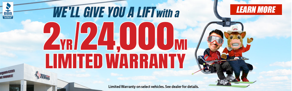 Man and TAC Mascot on ski lift talking about two year, 24,000 mile limited warranty.