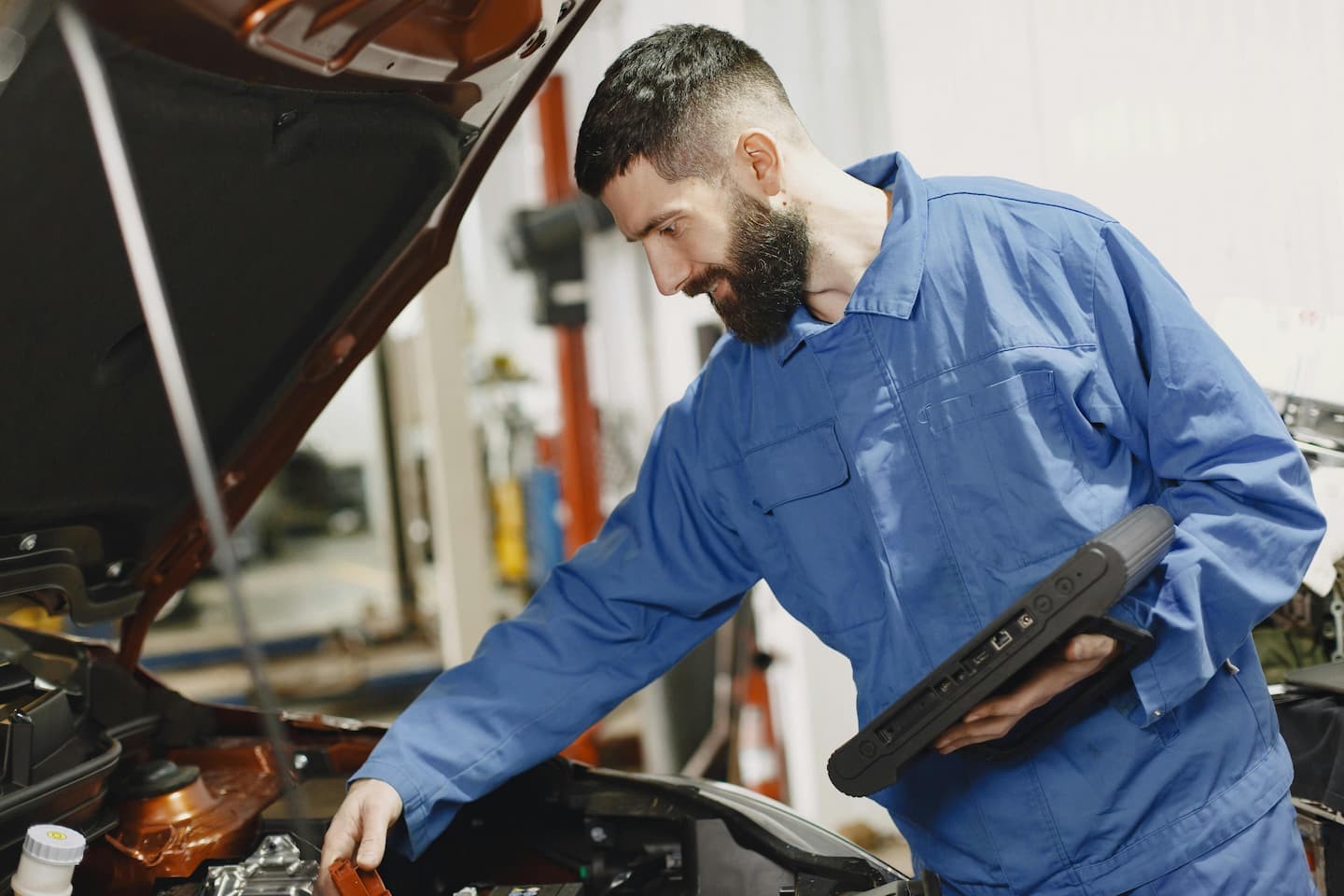 mechanic checking the condition of used car in austin, texas