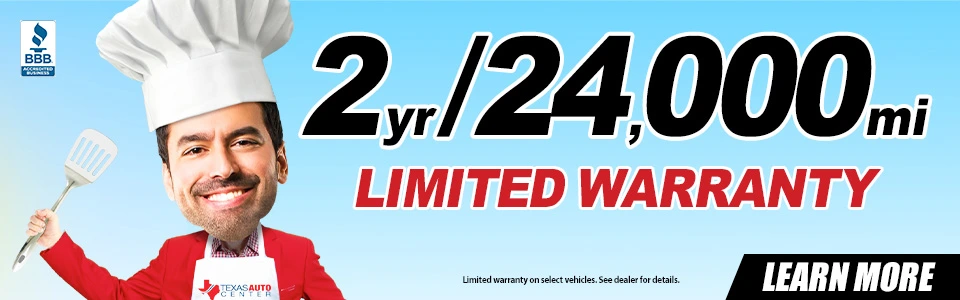 Austin customer receiving car keys with included 2-year 24,000-mile warranty, Texas Auto Center
